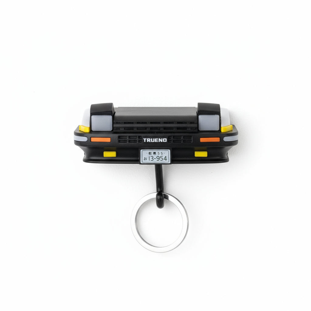 Wieszak na klucze w kształcie samochodu z otwieranymi reflektorami